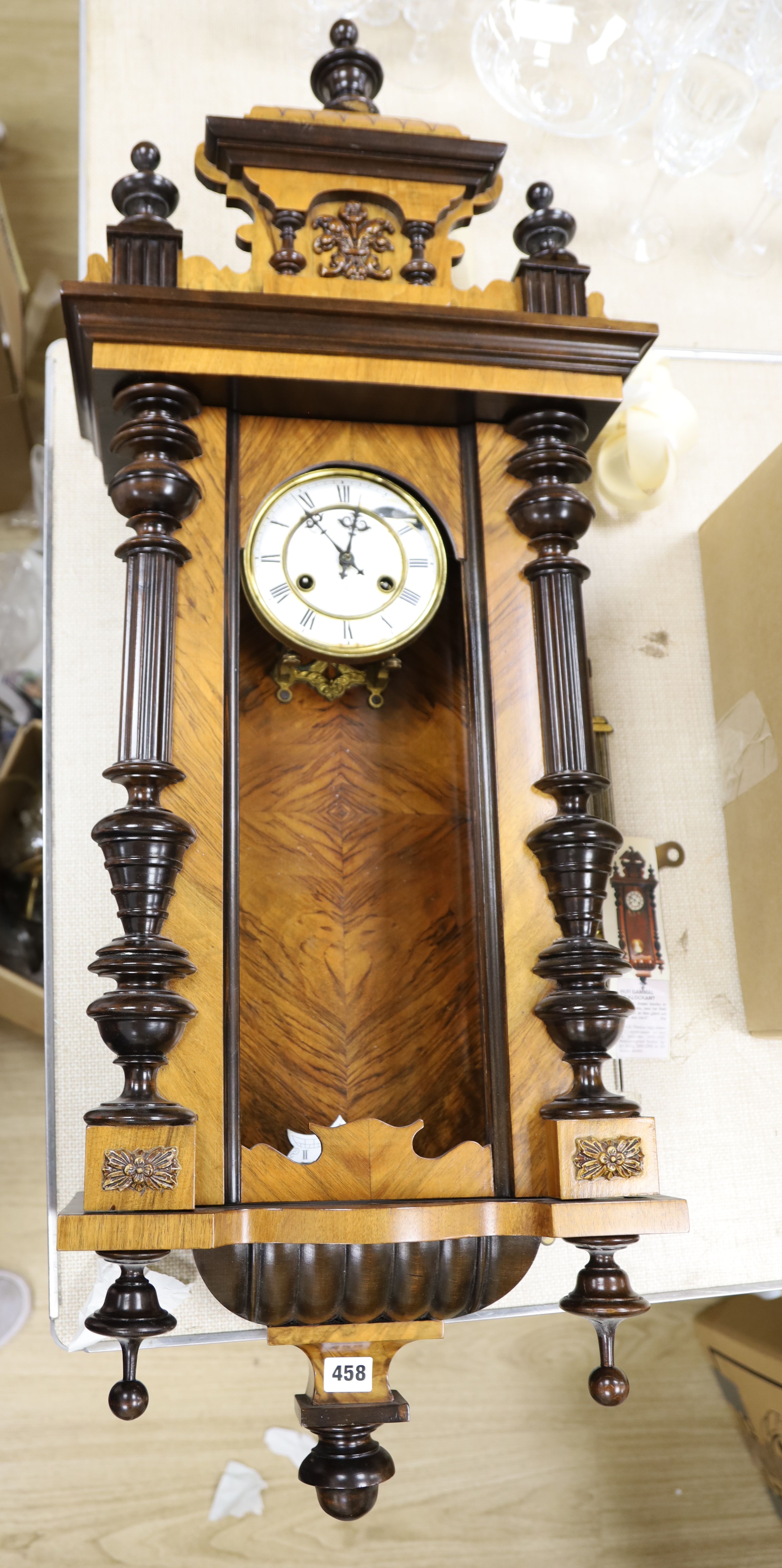 A 19th century German walnut wall clock, length 102cm